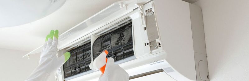 HVAC technician repairing an air conditioner unit in Bonsall CA